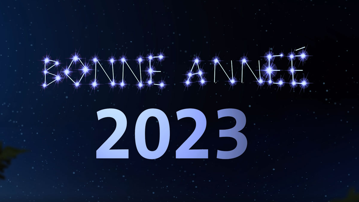 "Bonne année 2023" écrit en lumières scintillantes sur fond de ciel étoilé